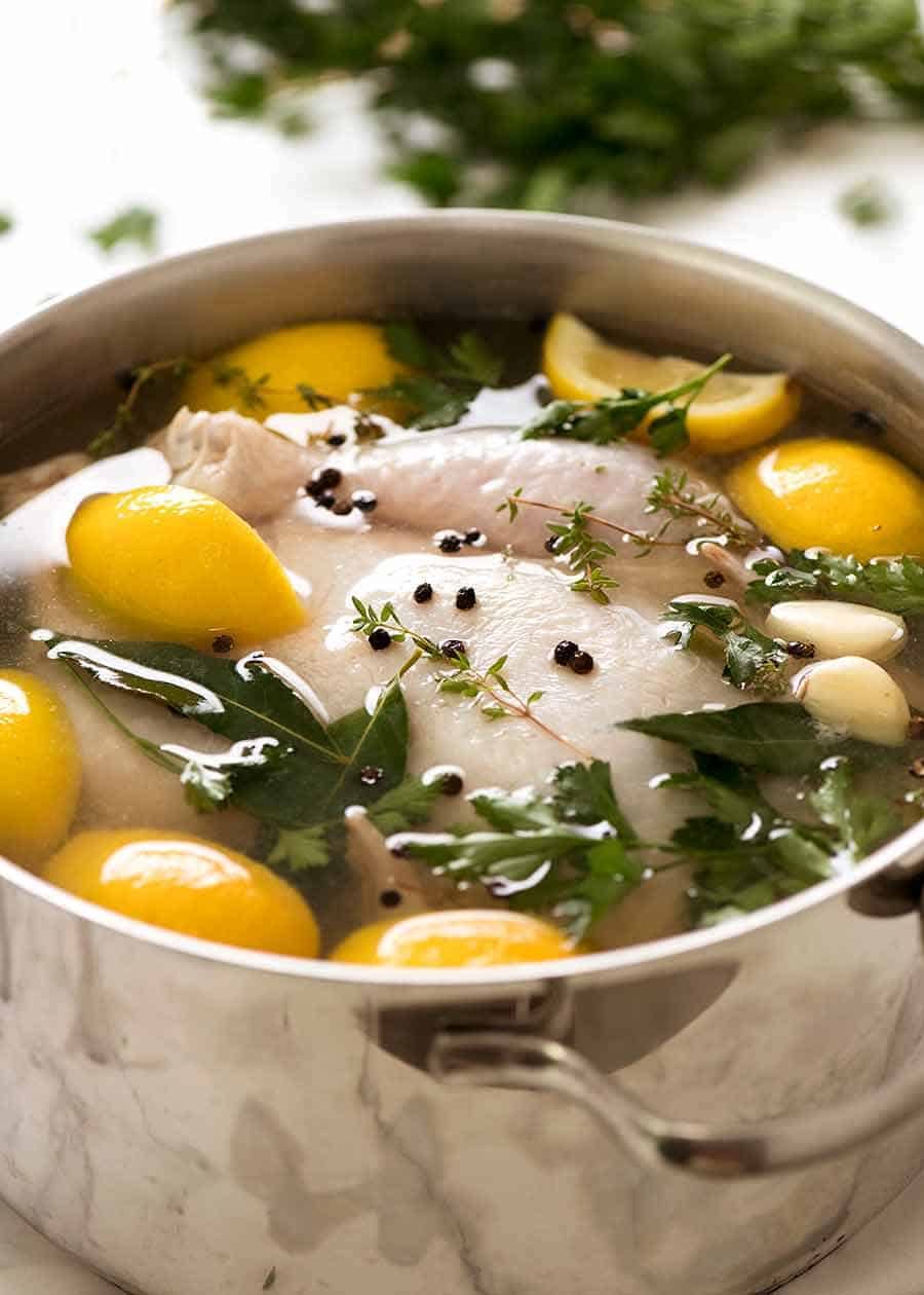 How to brine chicken - photo of whole raw chicken submerged in brine solution