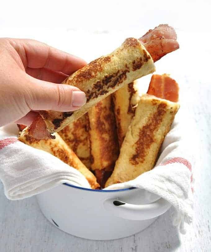 Bacon French Toast Roll Ups - crispy bacon rolled up in bread, dipped in egg mixture and pan fried golden brown. These need to be made with fresh, plain sandwich bread, not fancy artisan bread. #breakfast #brunch #french_toast #bacon #roll_up