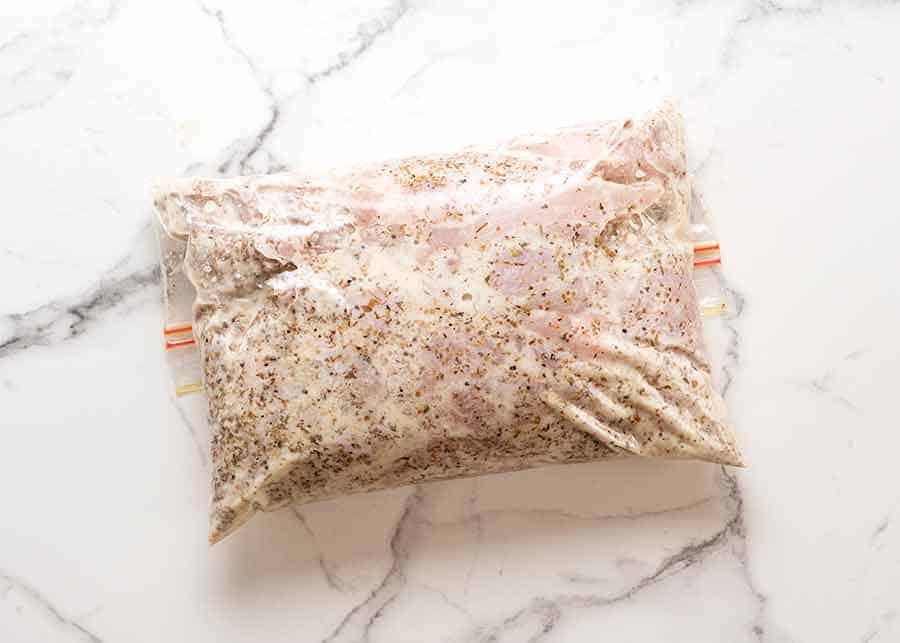 Chicken being marinated in Greek Chicken Gyros marinade