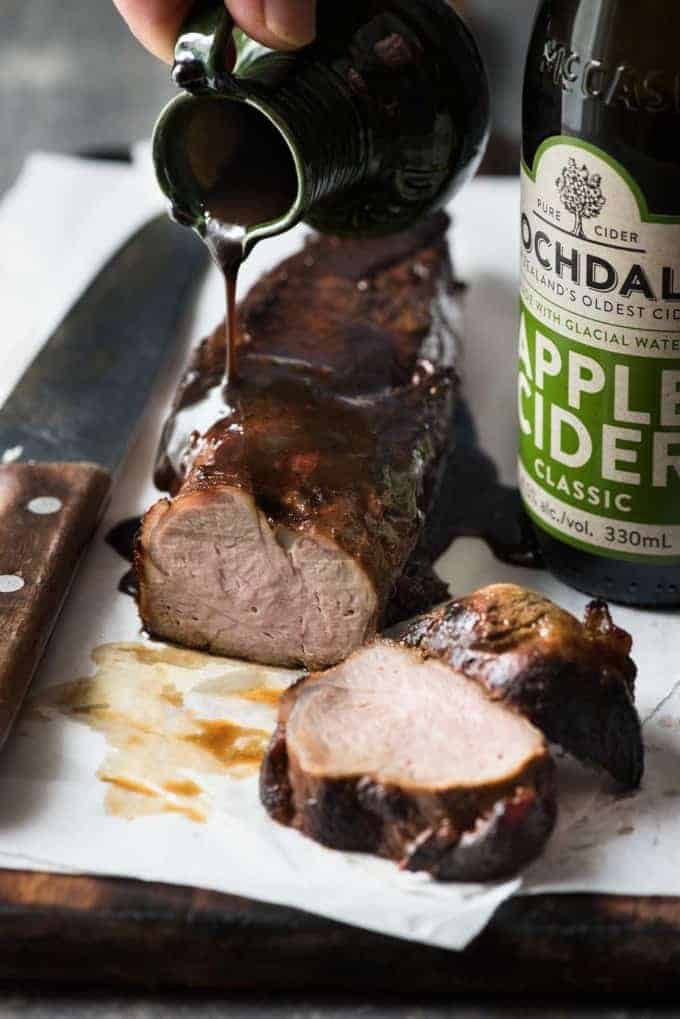 Apple cider glaze being poured over Pork Tenderloin