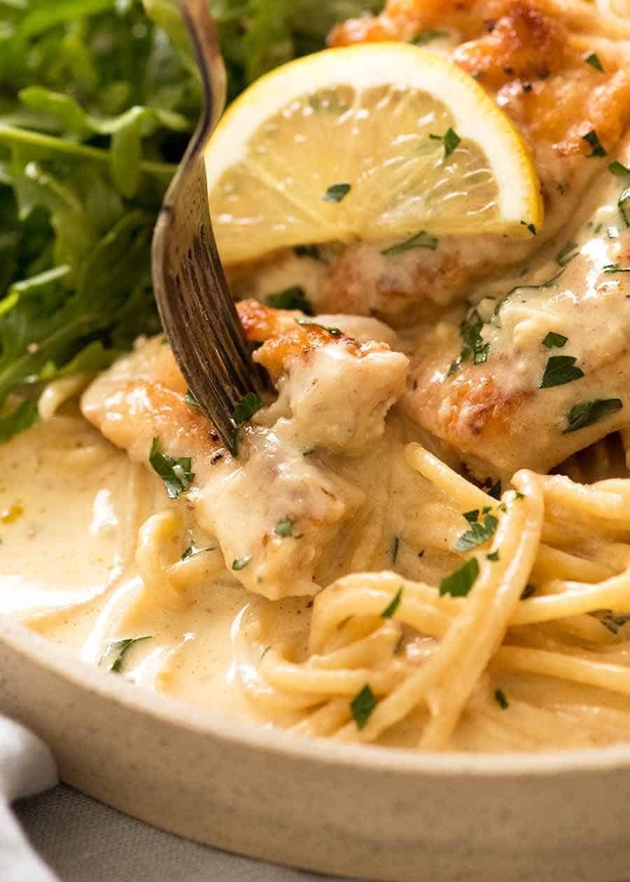 Close up of fork stabbing piece of Creamy Lemon Chicken Breast