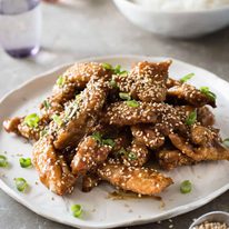 Easy Chinese Honey Sesame Chicken - BAKED, not deep fried, this chicken is coated in a gorgeous sticky irresistible sauce!