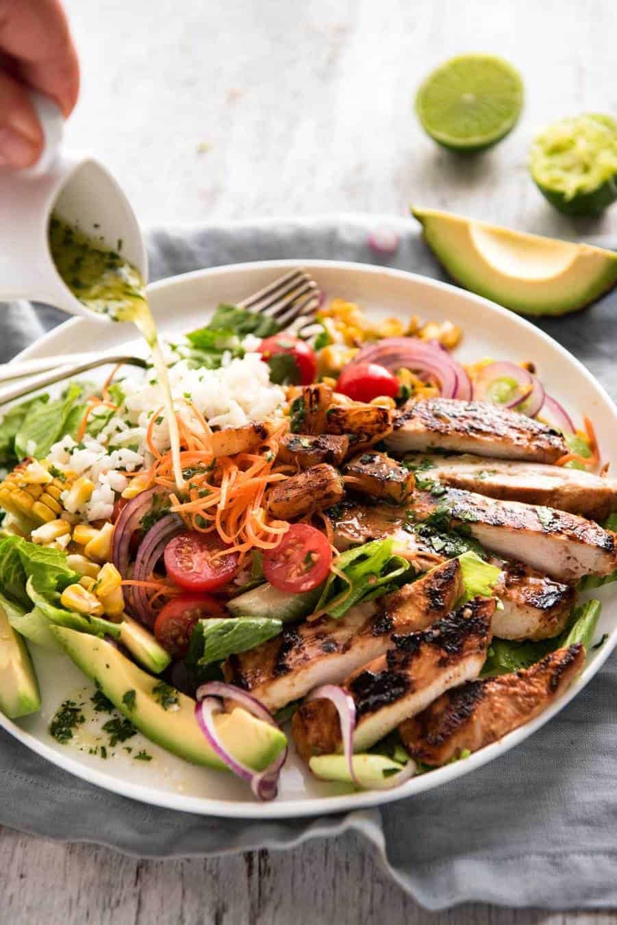 A salad with chicken marinated in pineapple juice, coconut milk & spices and a beautiful cilantro (coriander) lime dressing. The flavours of Hawaii - in a salad! recipetineats.com