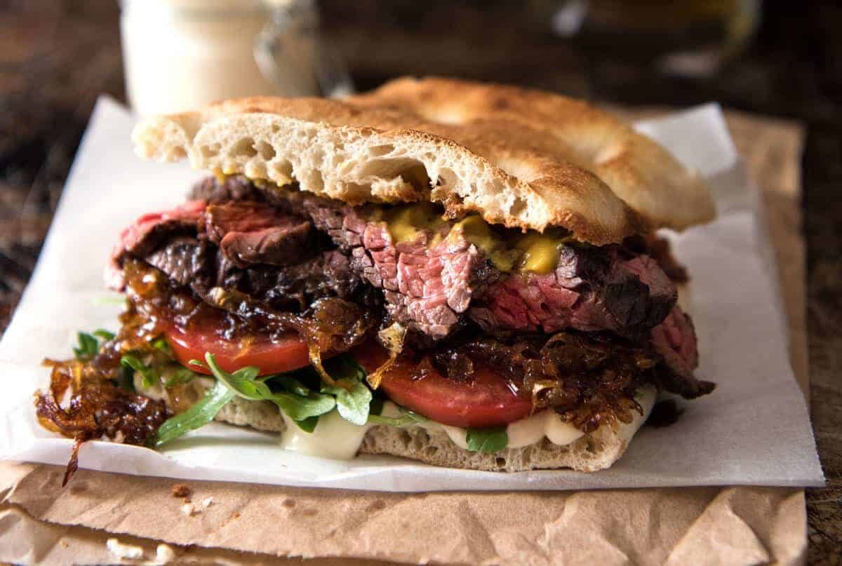 A juicy Steak Sandwich loaded with tender slices of steak, caramelised onion, garlic aioli, lettuce, tomato and mustard. www.recipetineats.com