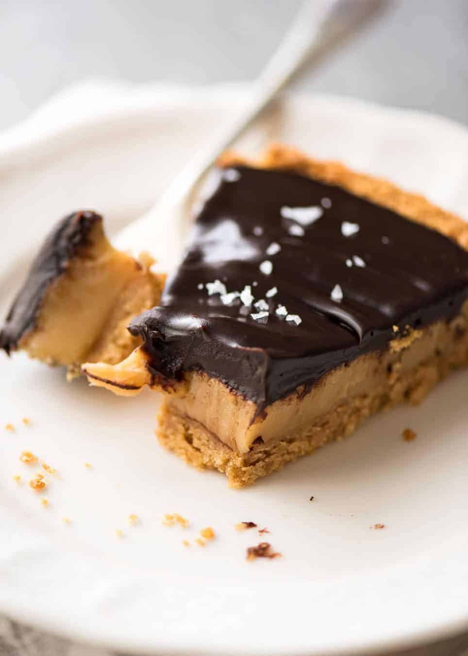 A sinfully decadent Salted Caramel Tart with a creamy soft salted caramel filling topped with luxurious chocolate ganache. Just SIX ingredients! www.recipetineats.com