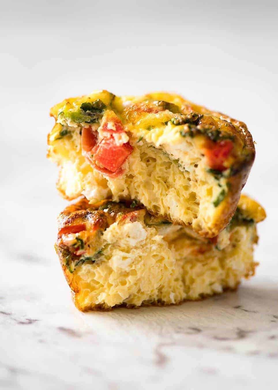 Healthy doesn't have to be bland! These Healthy Egg Muffins are a great grab & go breakfast option. Egg, spinach, feta, cherry tomatoes and bell peppers/capsicum. www.recipetineats.com