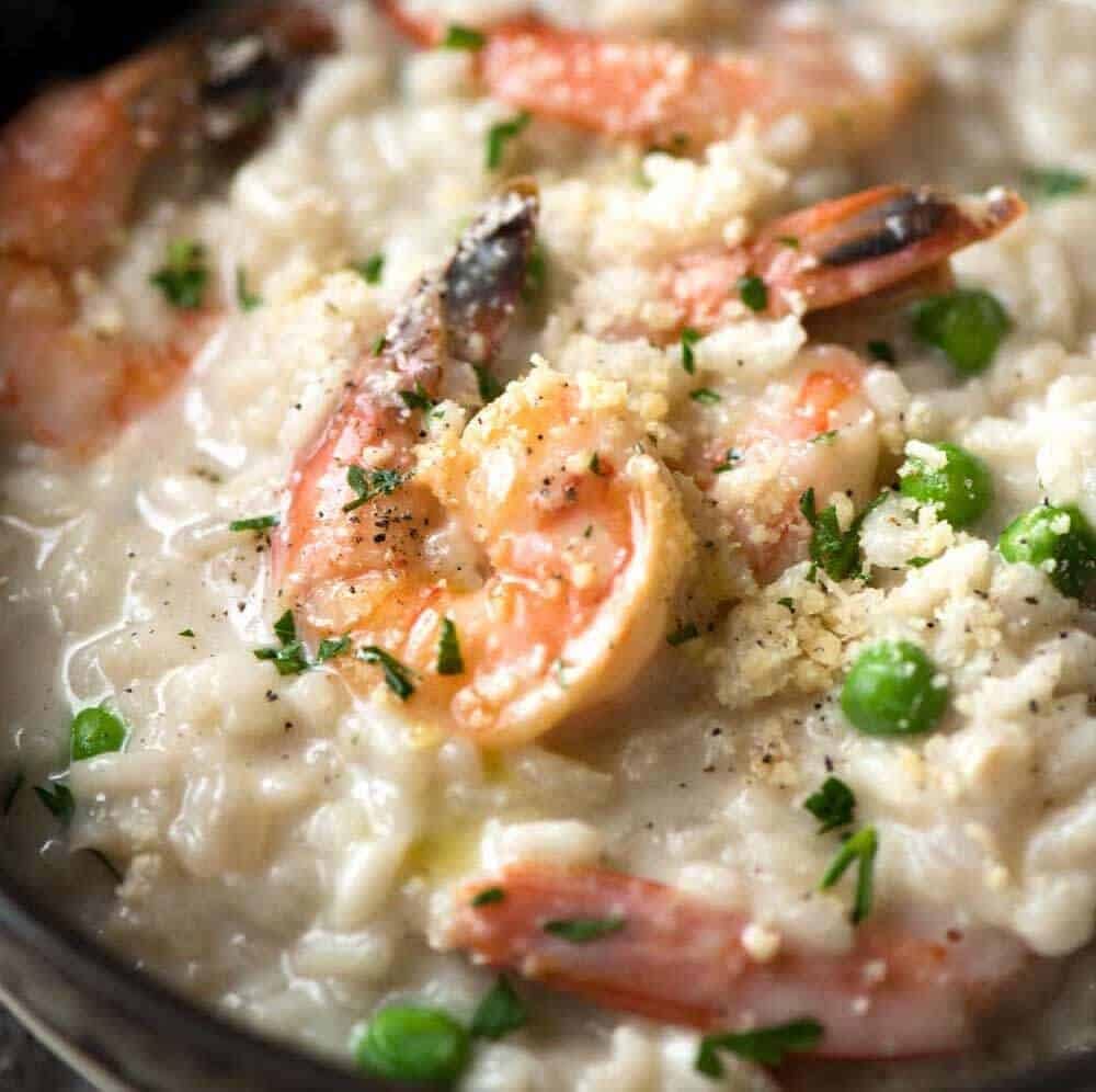 Close up of Prawn Risotto (Shrimp Risotto) in a dark brown bowl.