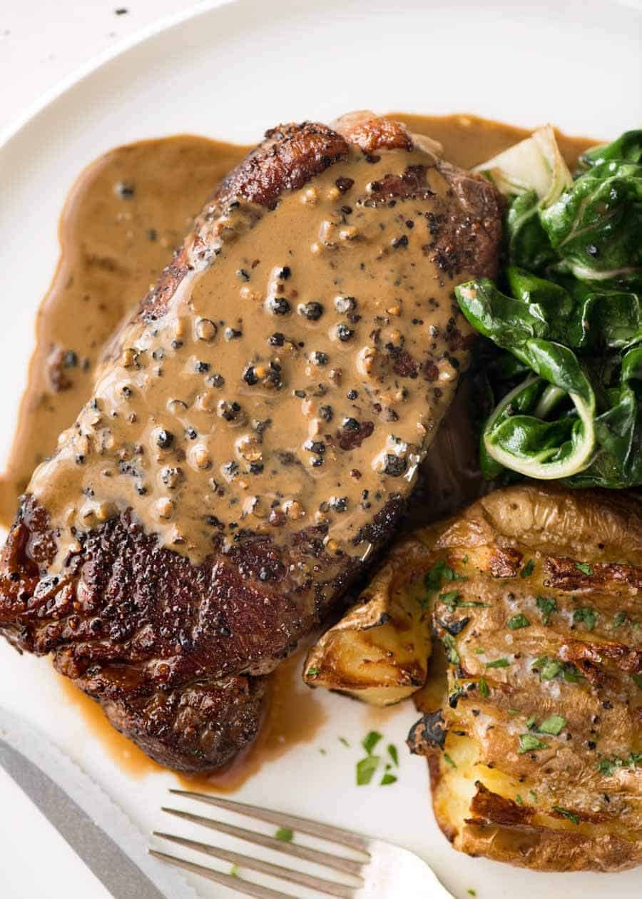 Overhead photo of Creamy Peppercorn Sauce on steak.