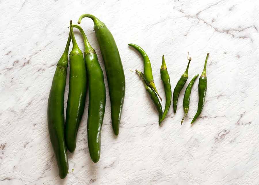 Green cayenne peppers and thai chillies