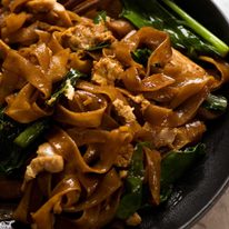 Close up of Pad See Ew - Thai Stir Fried Noodles on a plate, ready to be eaten