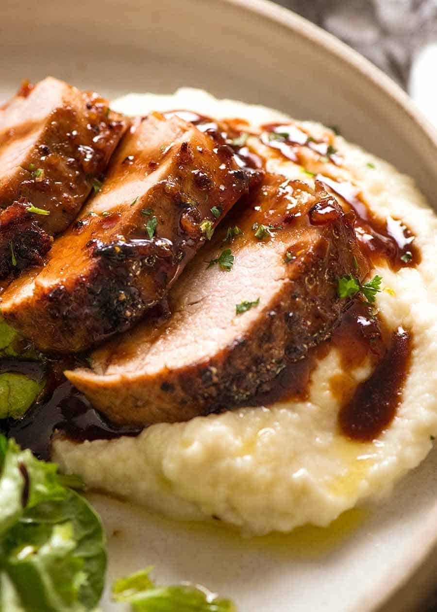Slices of Honey Garlic Pork Tenderloin on a bed of creamy mashed cauliflower