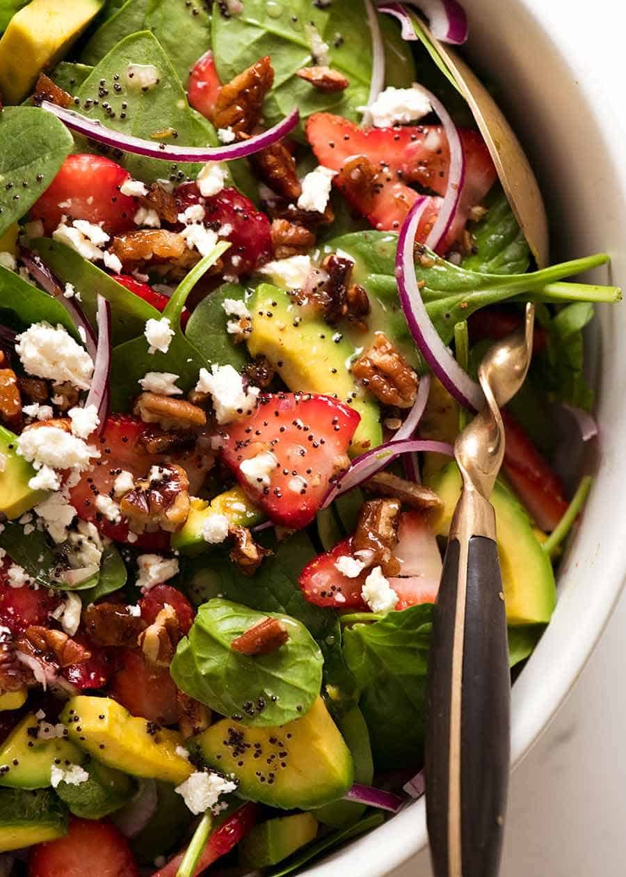 Close up of Strawberry Salad with Avocado in a white bowl, ready to be served
