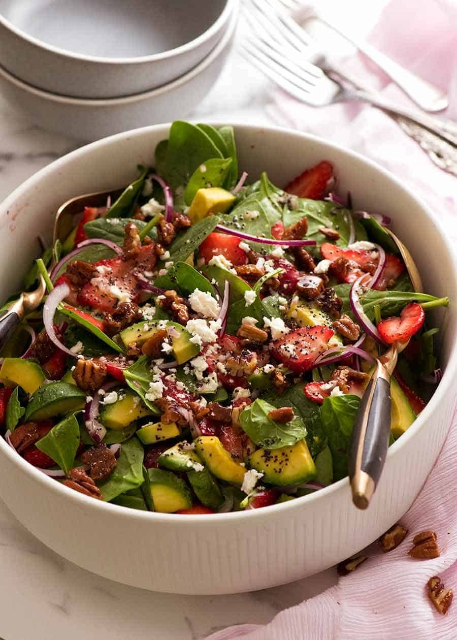 Strawberry Salad with Avocado in a white bowl, being served for lunch
