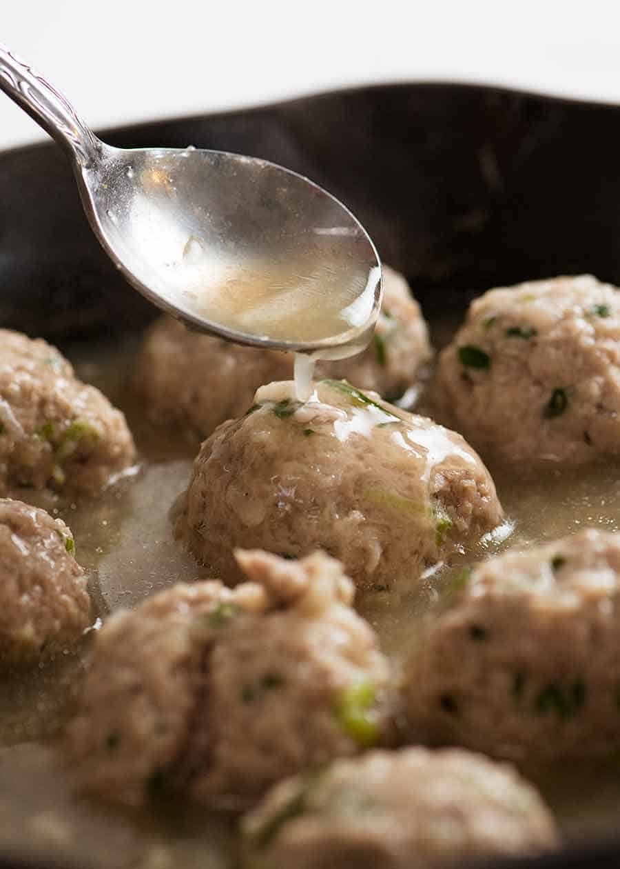 Spooning sauce over Vietnamese Pork Meatball for Vietnamese Sandwich