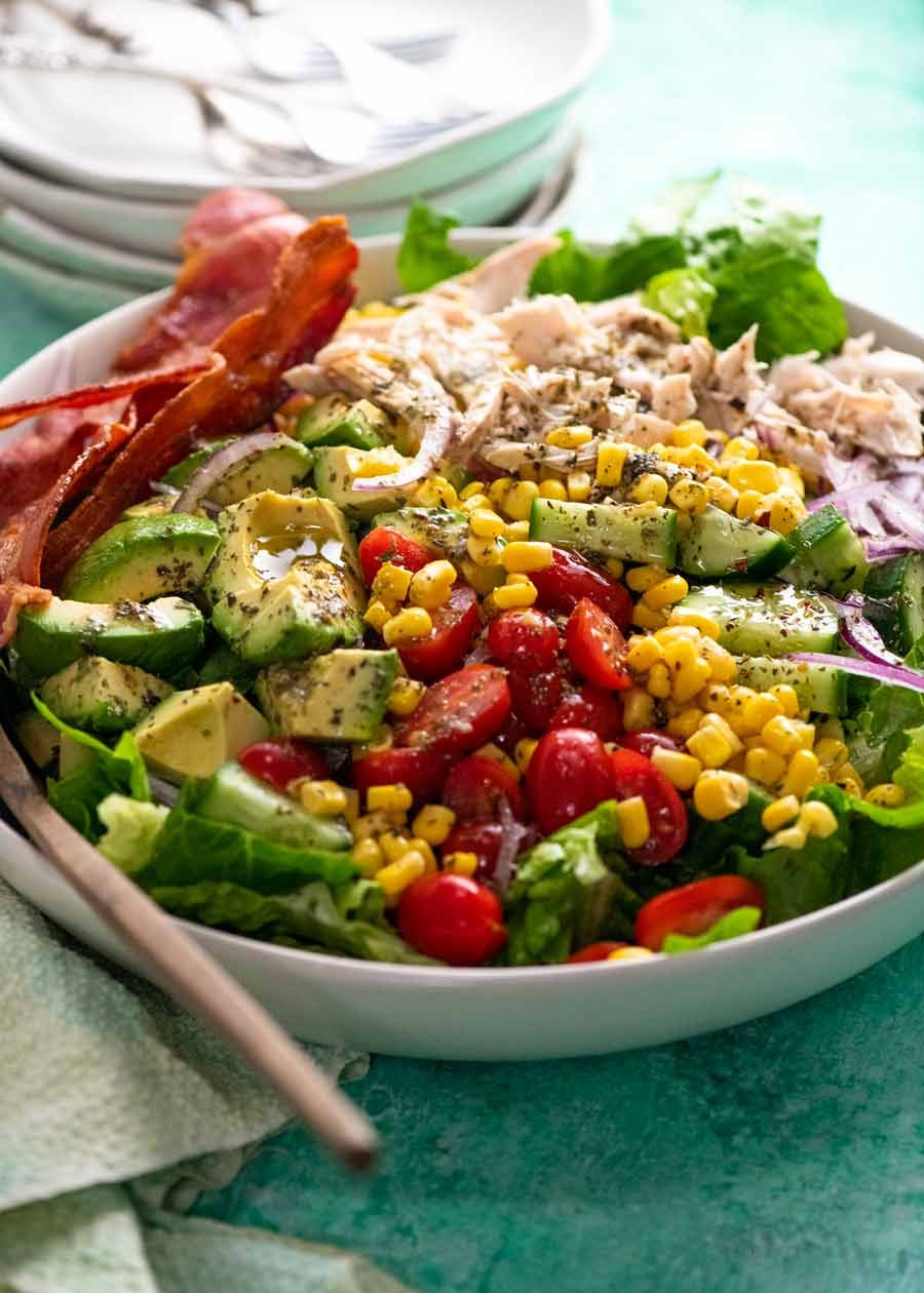 Chicken salad with herb and garlic dressing in a white bowl ready to be served