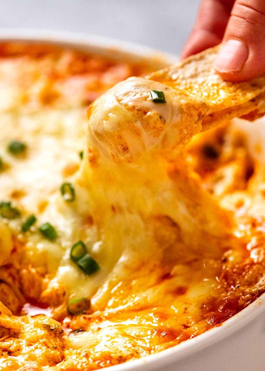 Scooping up cheesy Hot Buffalo Chicken Dip