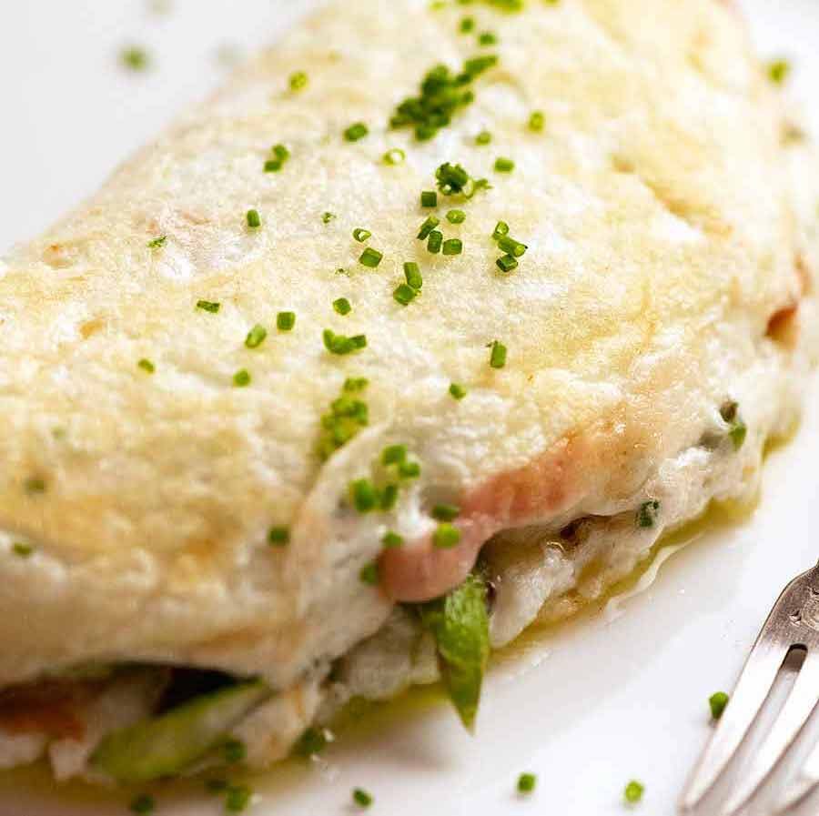 Fluffy Egg White Omelette on a plate stuffed with Asparagus and Prosciutto