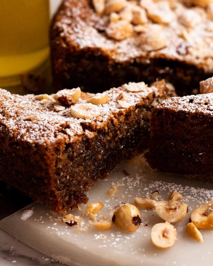 Pulling out a slice of Olive oil hazelnut cake