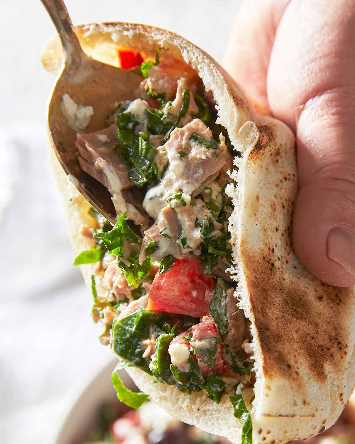 Stuffing pita pockets with Mediterranean tuna salad