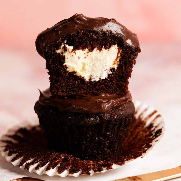 Whipped vanilla cream filled chocolate cupcakes with ganache frosting