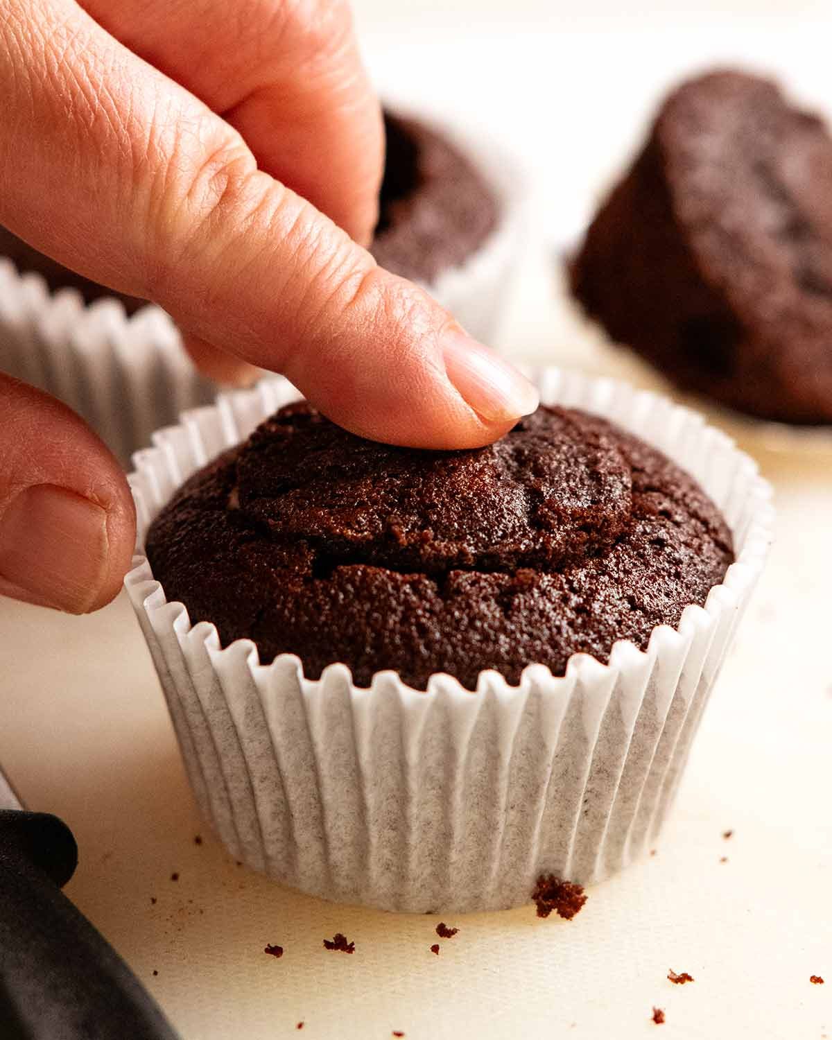Whipped vanilla cream filled chocolate cupcakes with ganache frosting